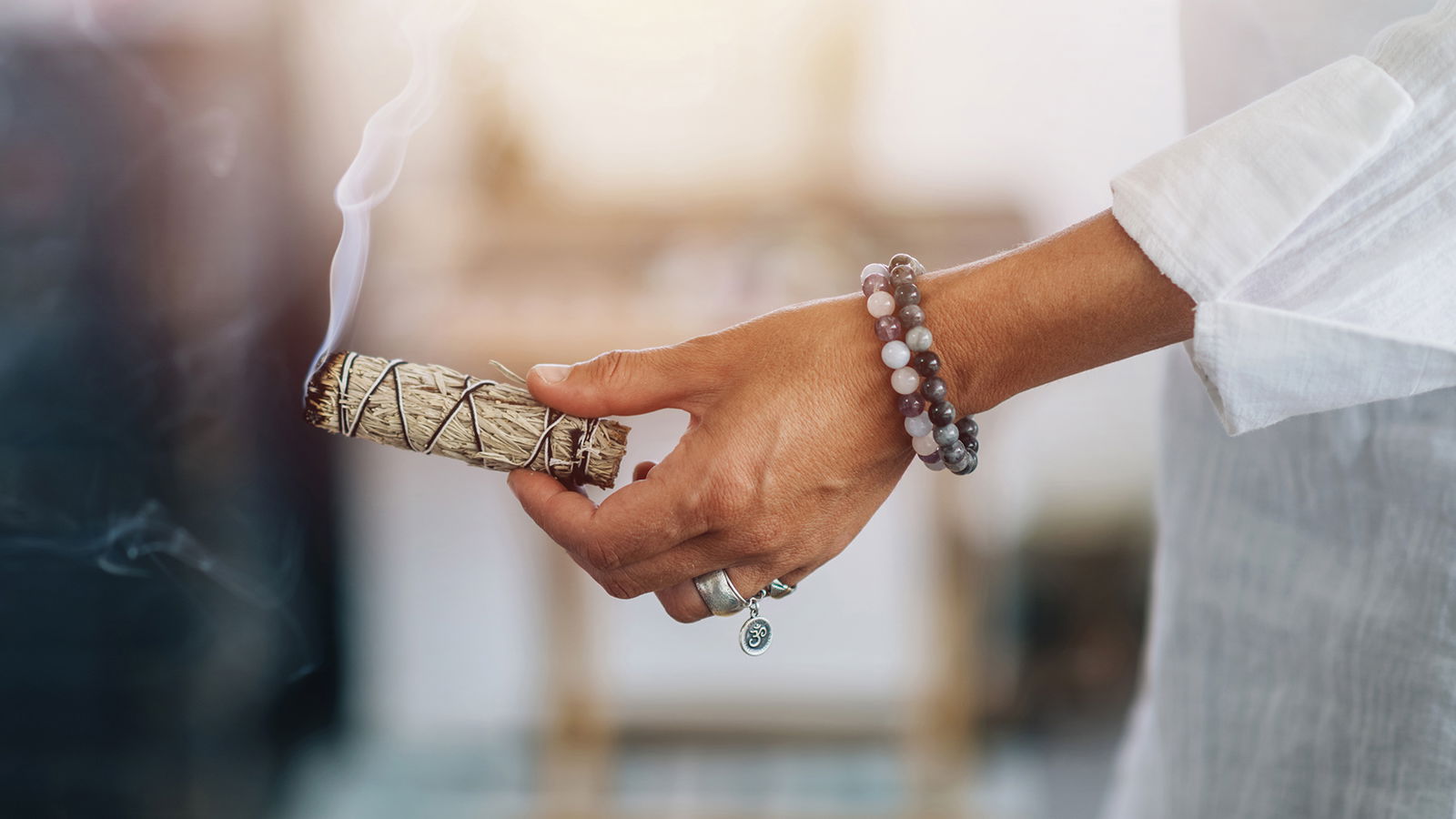 space healing burning candle surrounded by roses