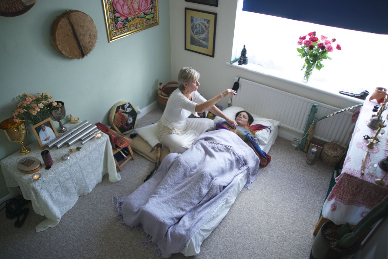 person laying down, taking part in energy healing