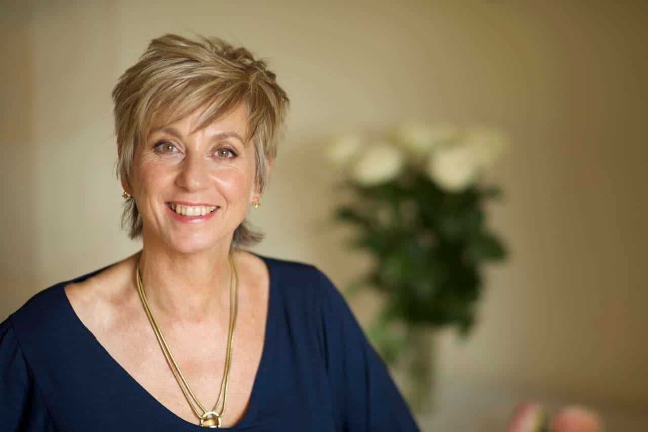 Sue Holmes completing a healing session with someone lay down next to her